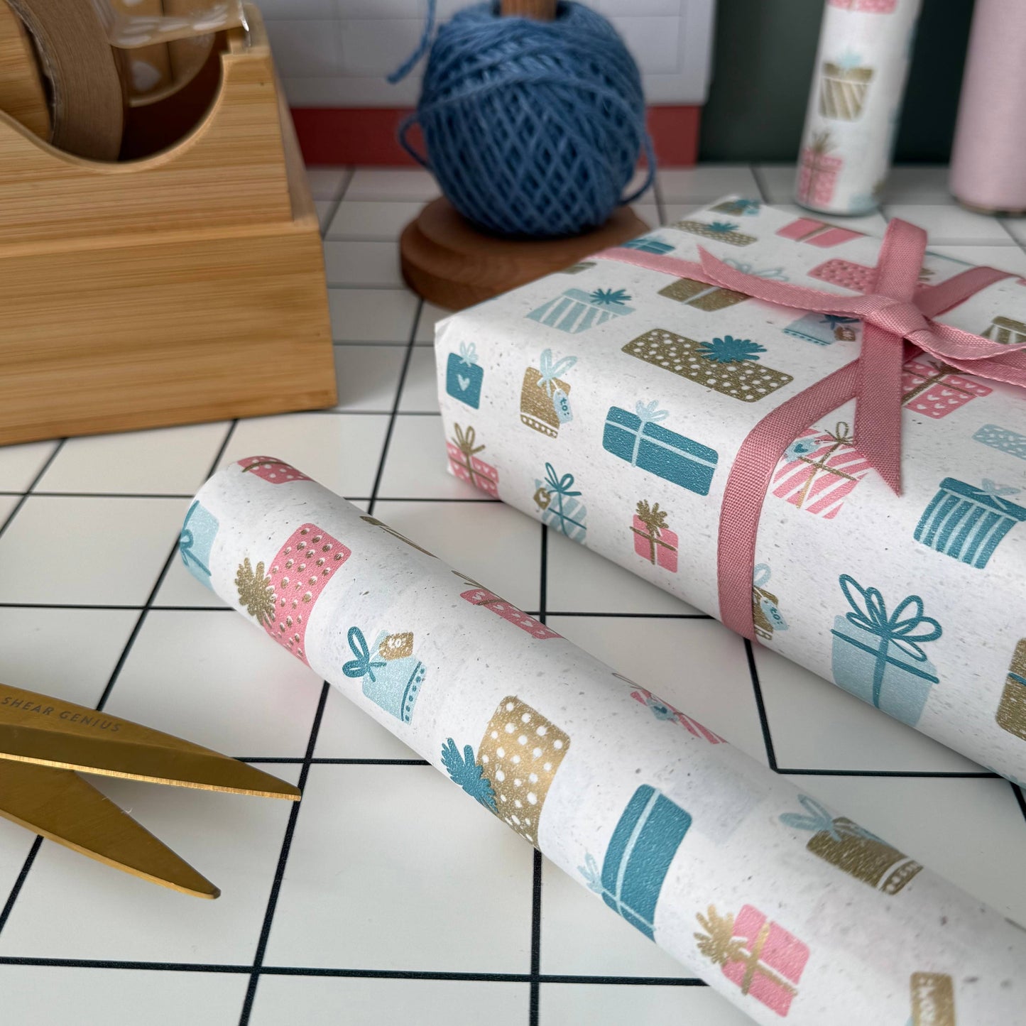 5m roll of eco-friendly present-design wrapping paper, 500mm wide, 100% recycled kraft, sustainably sourced, recyclable.