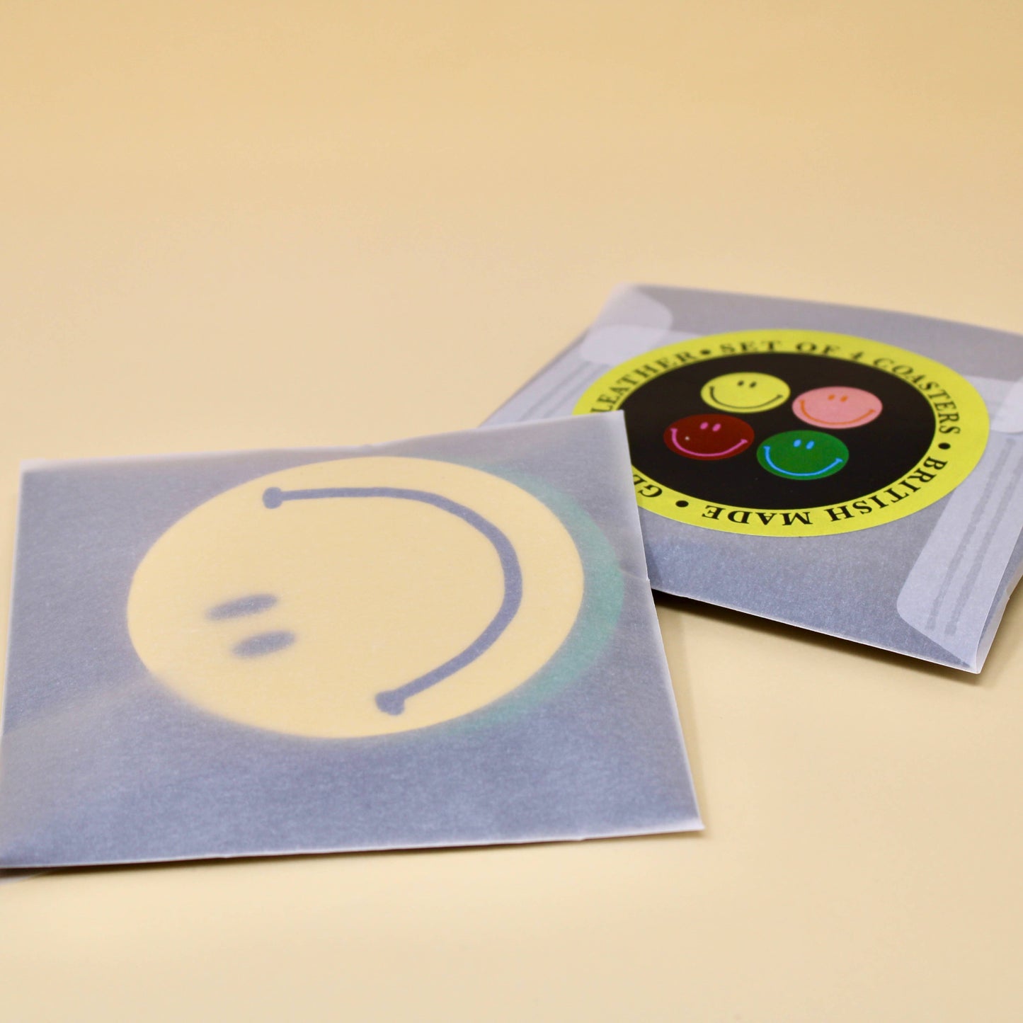 Happy Face Smilie Leather Coasters - Set of 4. Pink, Yellow, Green and Burgundy. Designed and made in the UK.