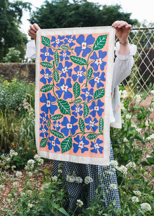 Primrose tea towel with floral screenprint on unbleached natural cotton by Studio Wald.