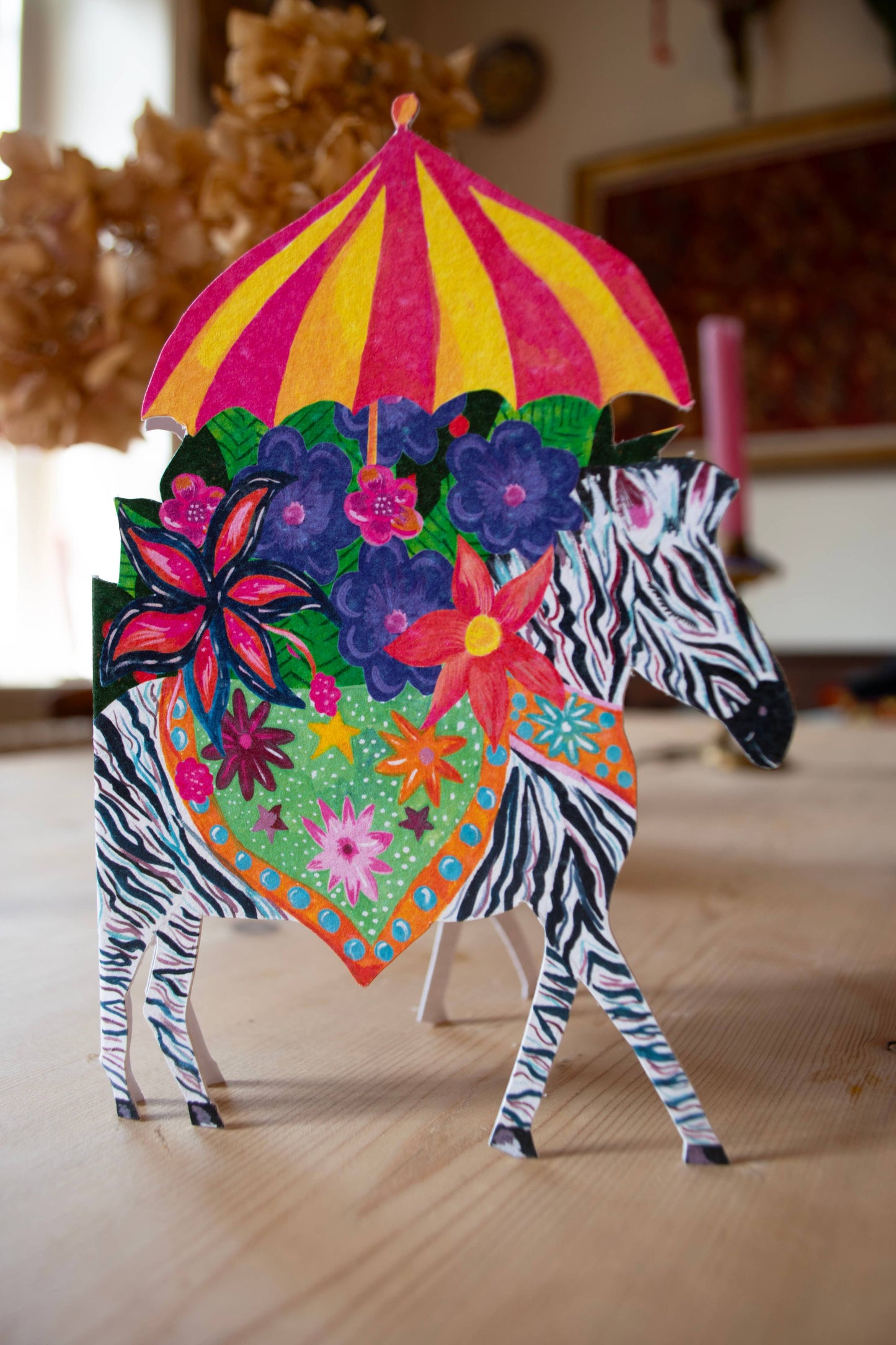 Close-up of the 'Zebra Parade' die-cut card, showcasing the intricate illustration and sustainable card quality.