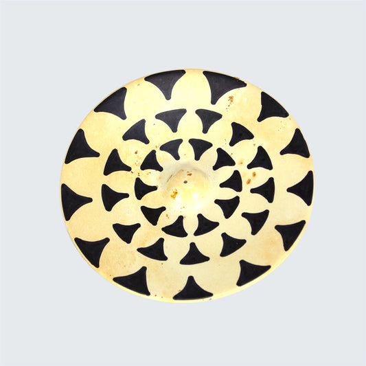 Hand-carved circular soapstone incense stick holder in black & white swirl pattern, ethically sourced and heat-resistant