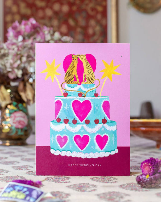 Close-up of Hutch Cassidy 'Tiger Wedding Cake' card illustration: two loving tigers on a cake with hearts and cherries. Sustainable greetings card.