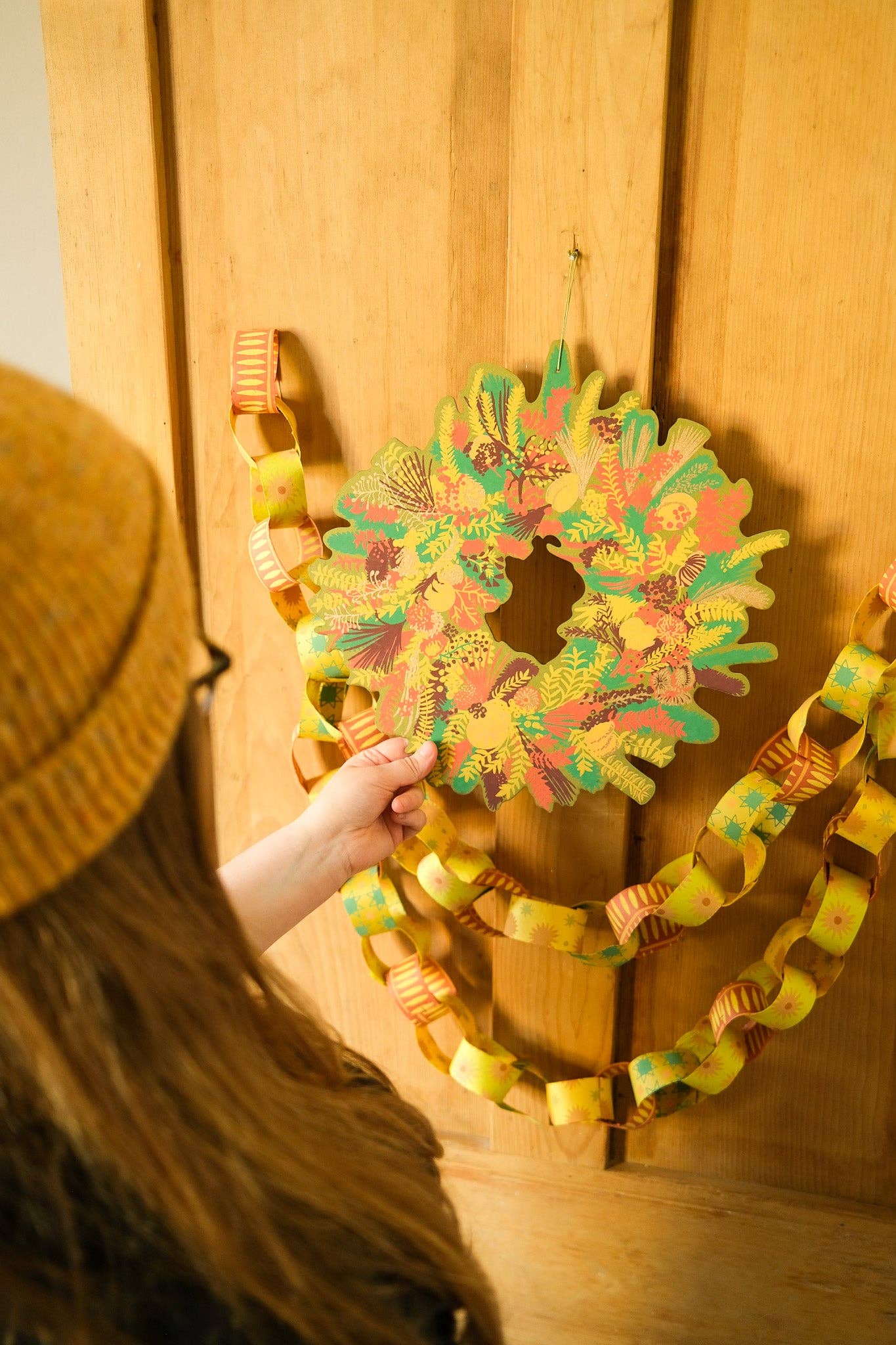 Hand-printed cotton board wreath with winter blooms, sustainable Christmas ornament