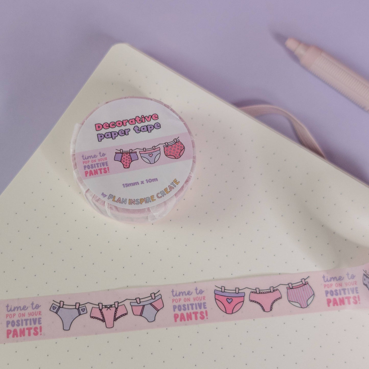 Pink and purple patterned pants washi tape with “pop on your positive pants” message and eco-friendly paper packaging—perfect for uplifting journaling and craft projects.