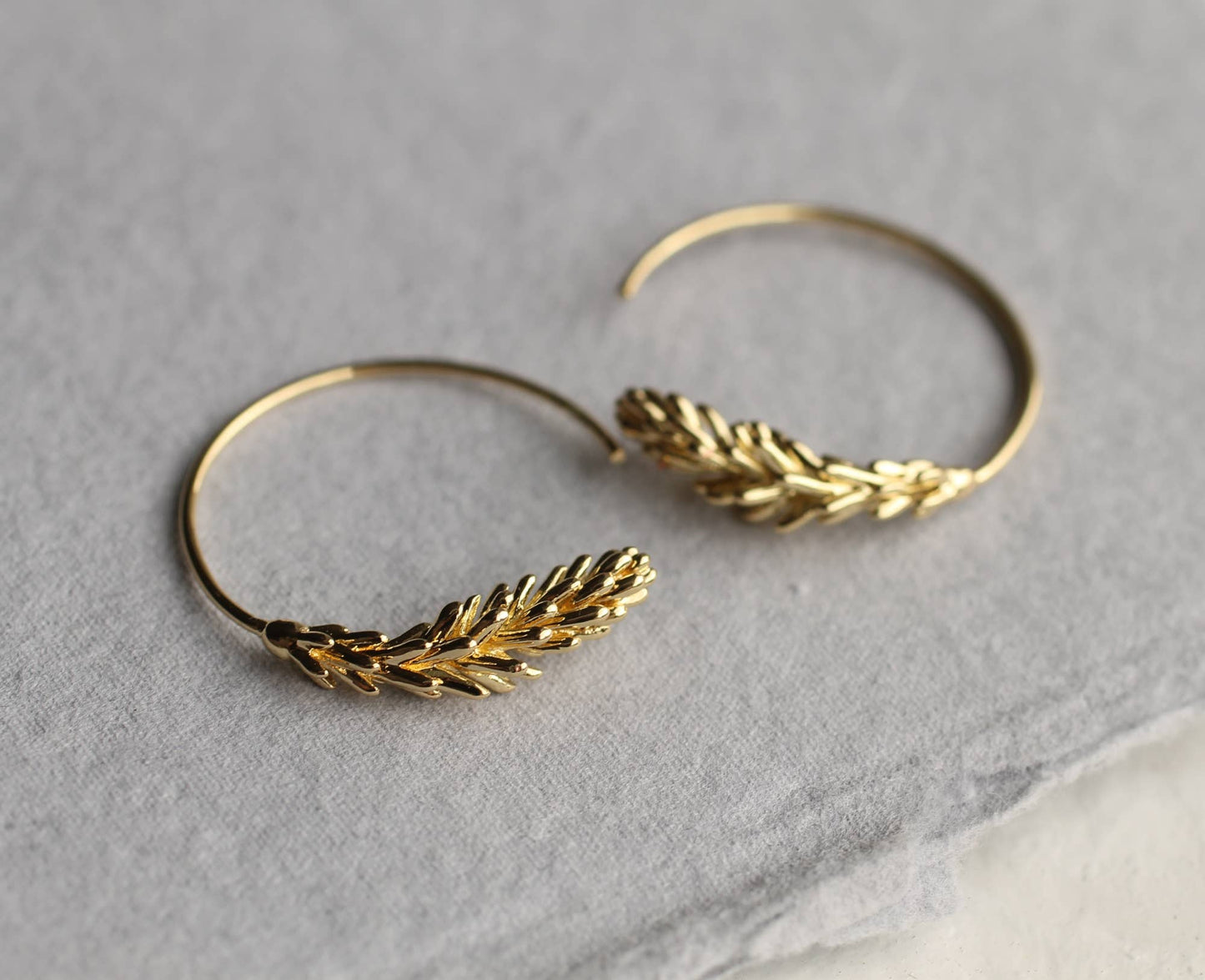 These rosemary leaf hoop earrings are made from plated brass with some amazing detail on the leaves. They feature a detailed botanical sprig of leaves, in a choice of gold. The hoop earrings measure 30mm in diameter and come with butterfly earring backs for a secure fit.
Designed and crafted in the UK.