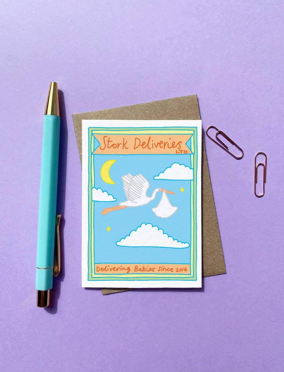 Close-up of the Stork Deliveries A7 new baby card, showcasing the hand-drawn stork graphic and vintage matchbox design. Blank inside, with a Kraft envelope.