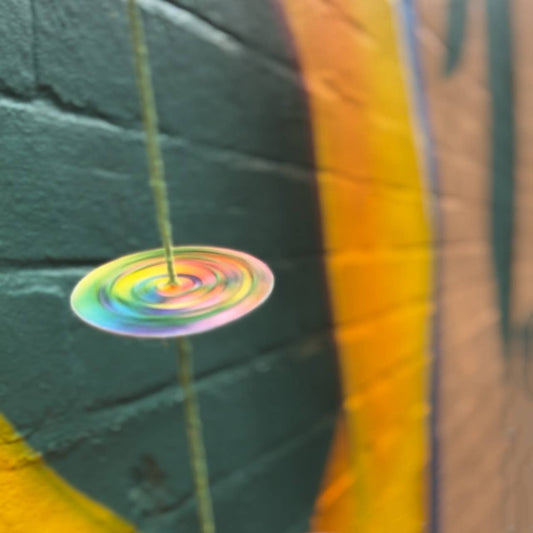 Completed colourful spinning top from the Make Your Own Spinning Toys craft kit