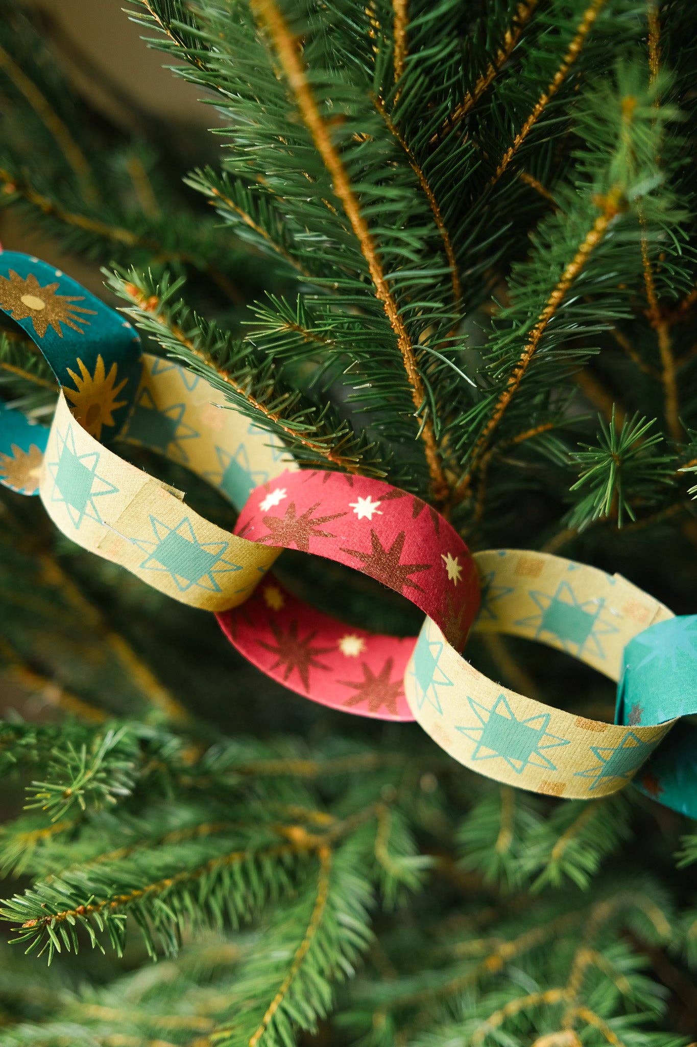 Recycled festive paper chain strips, hand-printed double-sided, eco-friendly decoration kit.