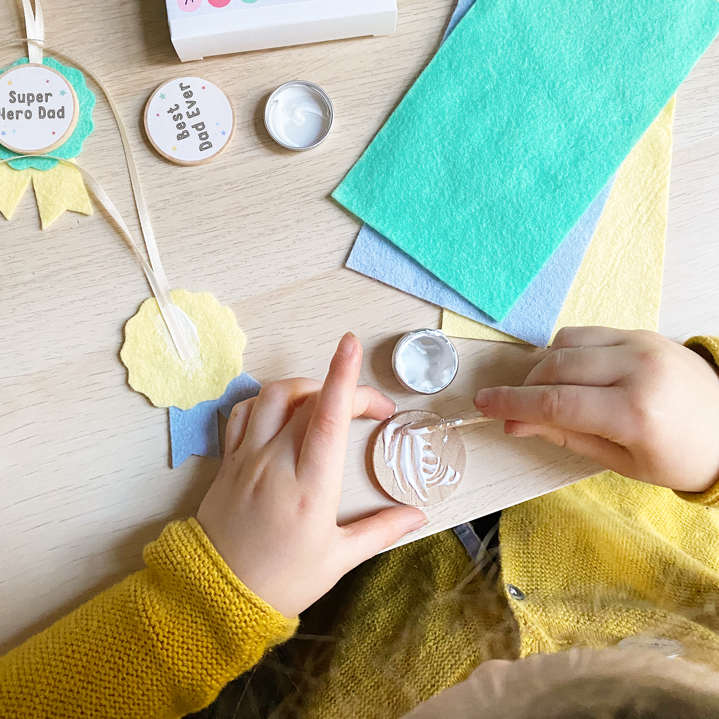 A child making the medals for their dad.