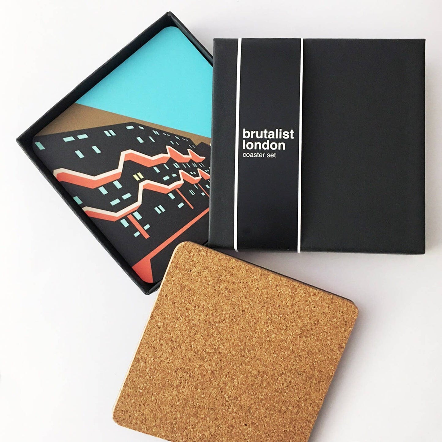 Brutalist London Coaster Set. Brutalist London Coaster Set. Set of 4 coasters featuring London Landmarks. Prints of Barbican, Brixton, Croydon and National Theatre. These coasters feature some of the most iconic Brutalist structures of London. One Croydon, the Barbican Tower, Southwyck House, Brixton and the National Theatre in South Bank.
Specs: The coasters measure 10 x 10cm, about 5mm thick. Cork backed hardboard, and matte laminated finish.
They come in a smart, minimal black match-box style packaging