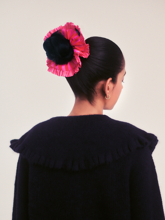 Close up of sustainable pink and red stripe scrunchie fabric