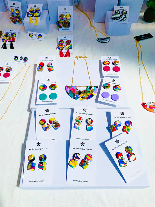 Model wearing 80s pop colour mini earrings, highlighting size and style