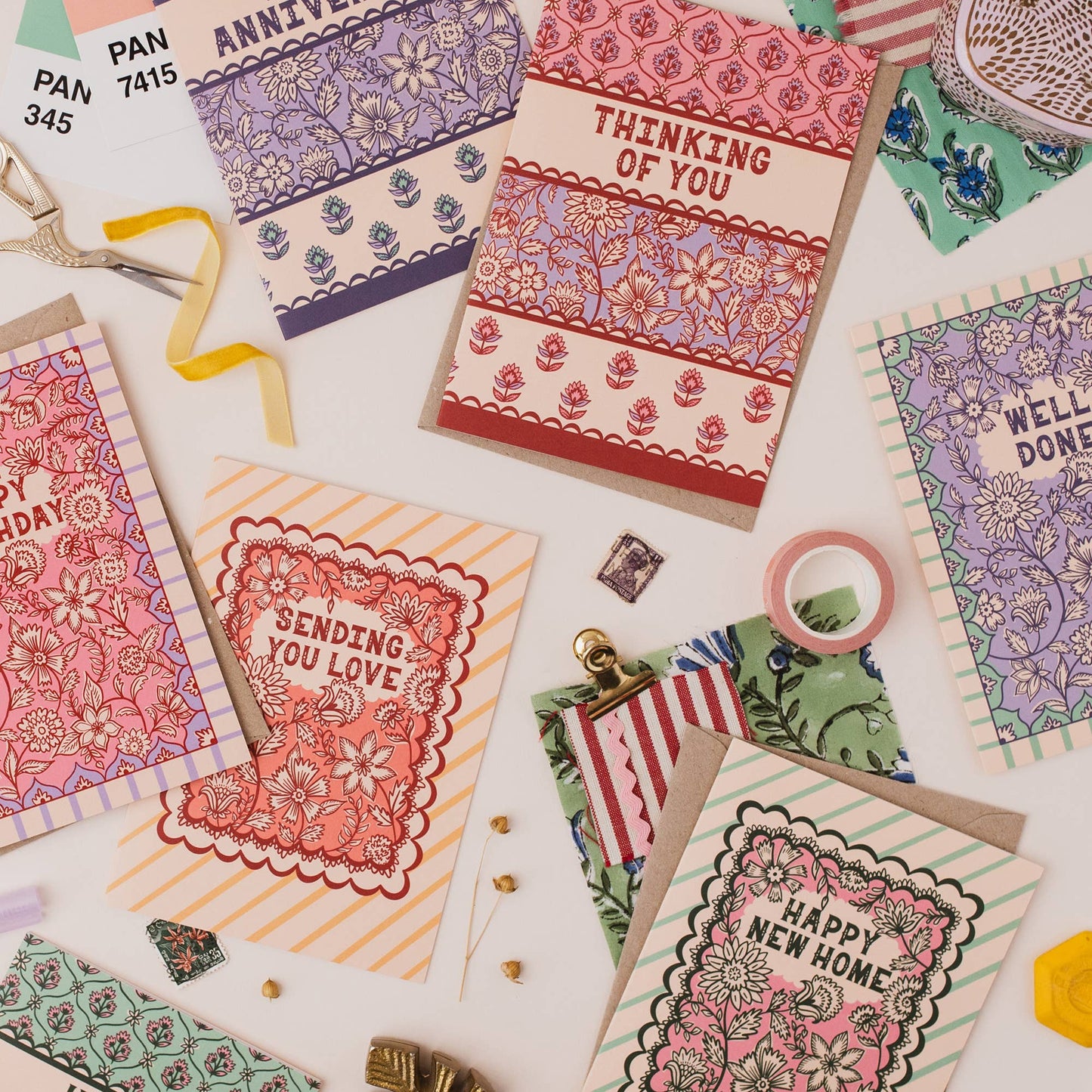 Hand drawn lettering reads 'Thinking of you'. Illustrated greeting card with Indian block print inspired floral pattern, printed onto premium matt card with a kraft envelope.