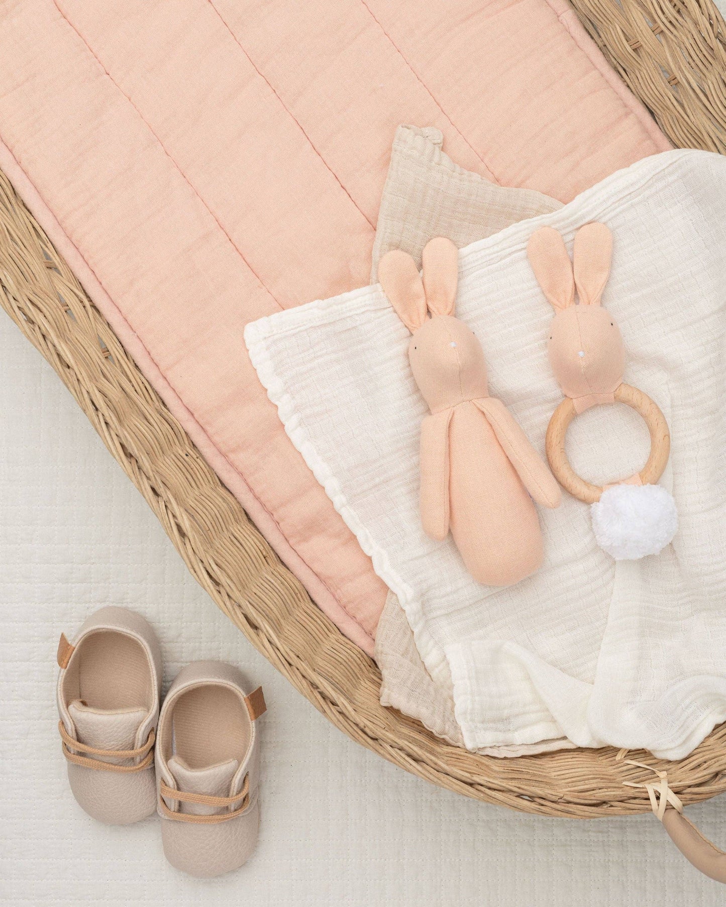 Rabbit teether for babies, featuring a plush cotton body and a natural beech wood ring, designed for tiny hands and teething relief.