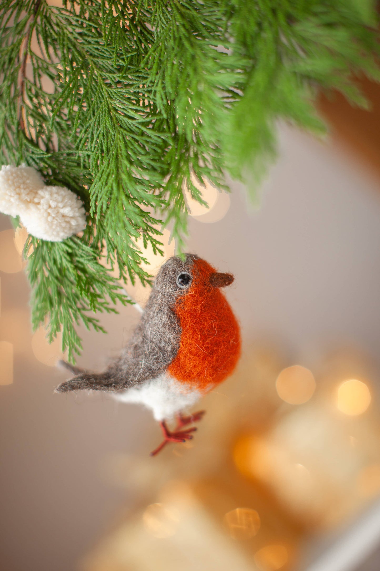 Handmade Robin Christmas decoration with detailed needle felting, beady glass eyes, and pom pom hanger, perfect for eco-friendly holiday decorating.