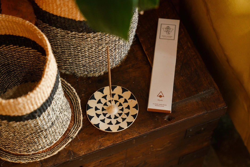 Hand-carved circular soapstone incense stick holder in black & white swirl pattern, ethically sourced and heat-resistant