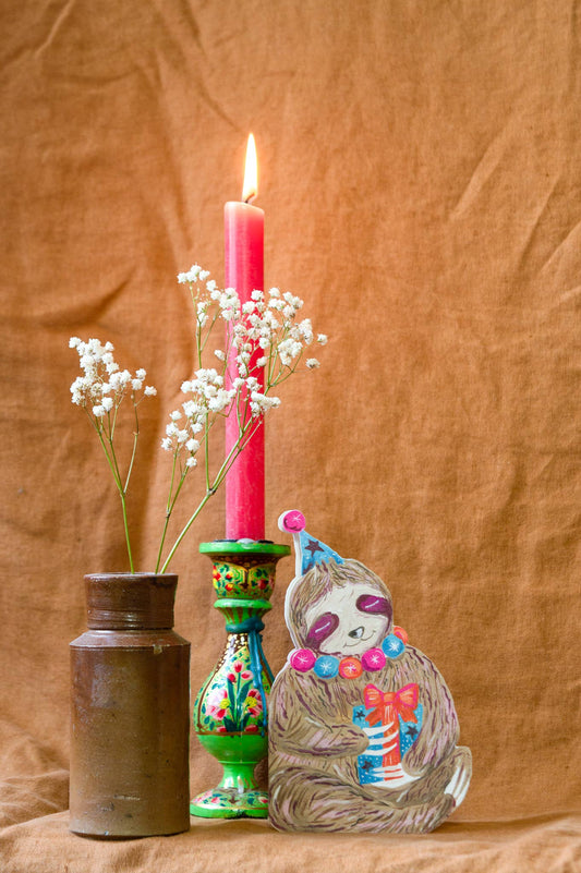 Close-up of illustrated party sloth detail on high-quality card