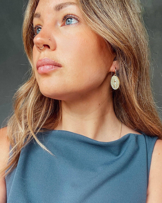 Close-up of Pearly Mint Seaweed Oval Hoop Earrings, gold etched detail