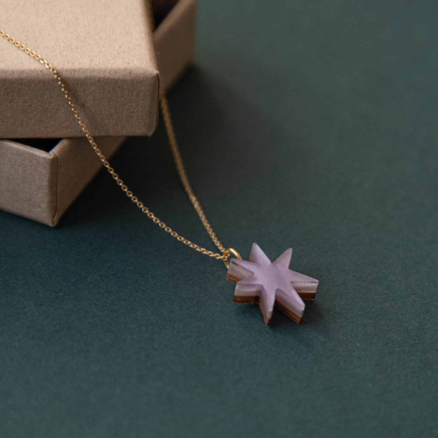 Close-up of Hand-Drawn Star Gold Necklace, Lilac Marble, on model