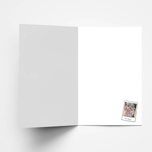 Close-up of illustrated wedding card, displaying a vibrant celebration with 'Happy Wedding Day' text.