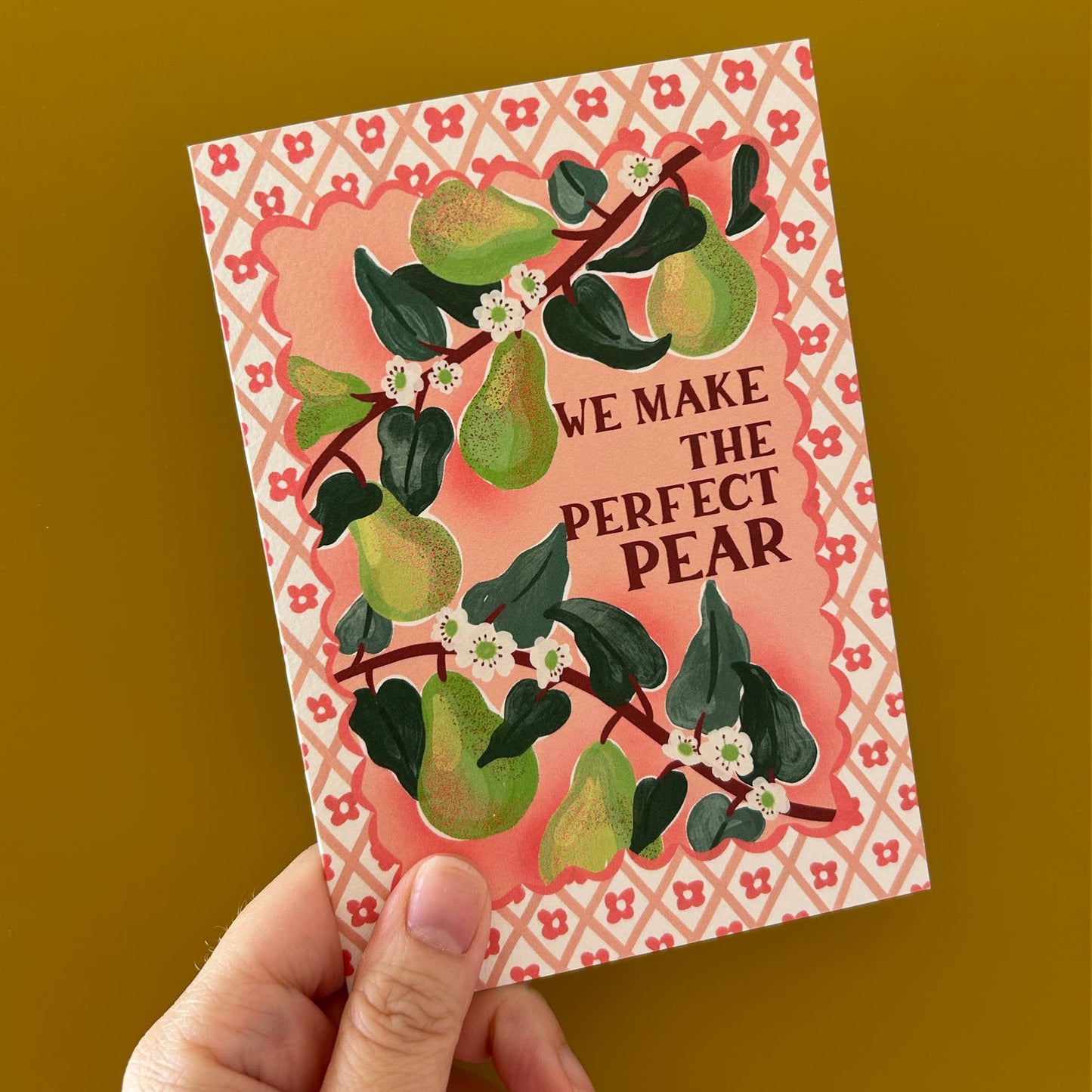 Hand holding a 'Perfect Pear' Valentine's card with a charming Italian fruit illustration