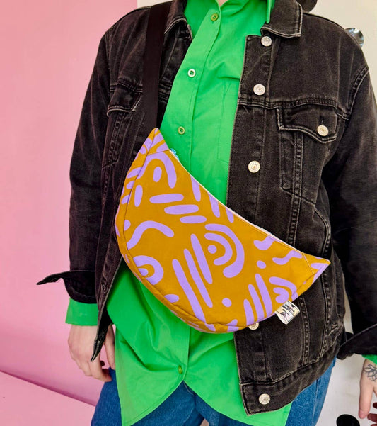 Detail of Lilac Graphic on Ochre handprinted design on Yolla Studio waxed canvas sling bag.