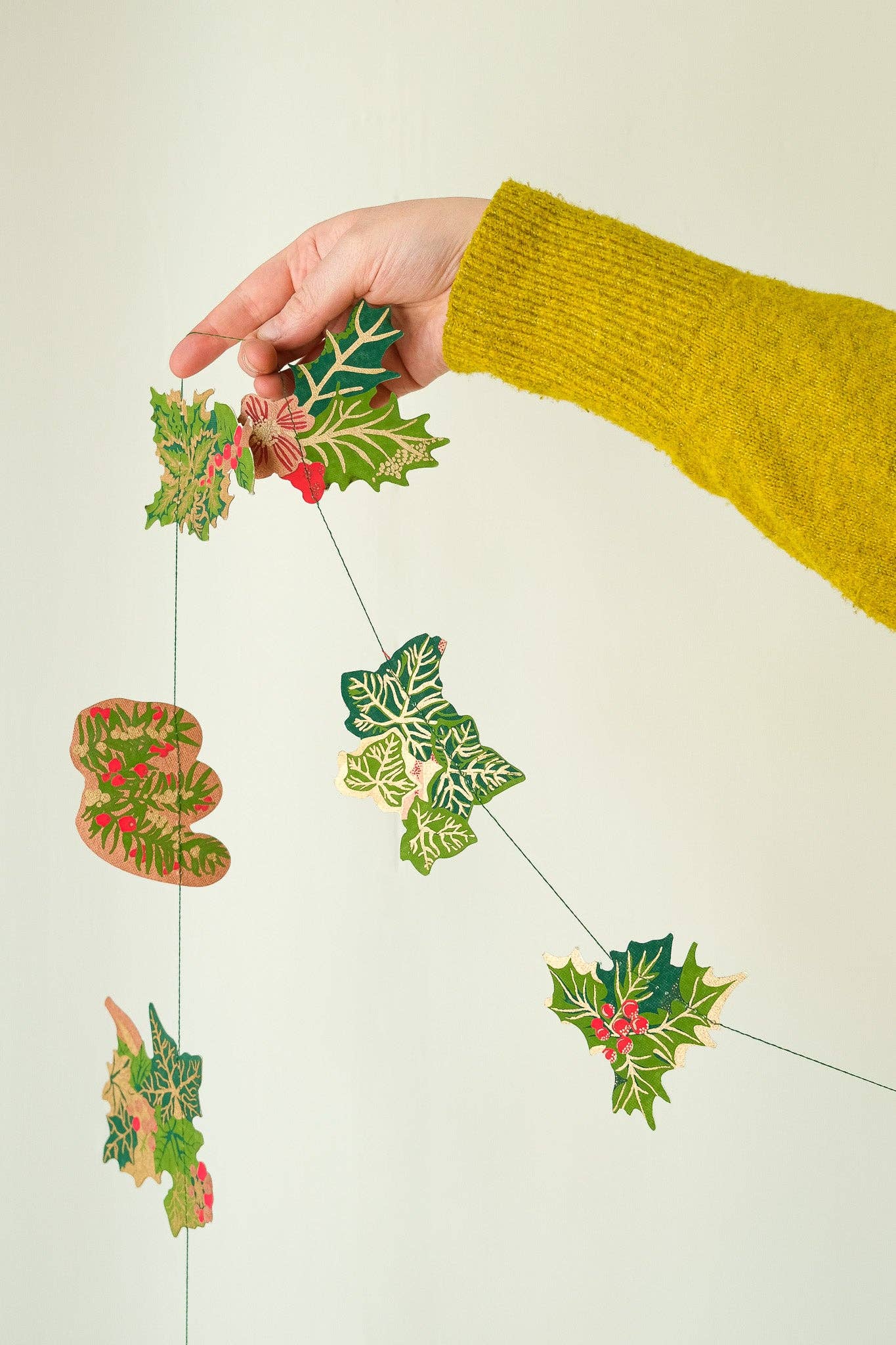 Hand screen printed Holly and Ivy Sewn Garland by East End Press on recycled paper with cotton thread