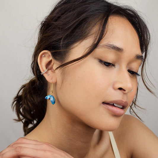 Model wearing delicate Bluebell vintage glass and brass earrings