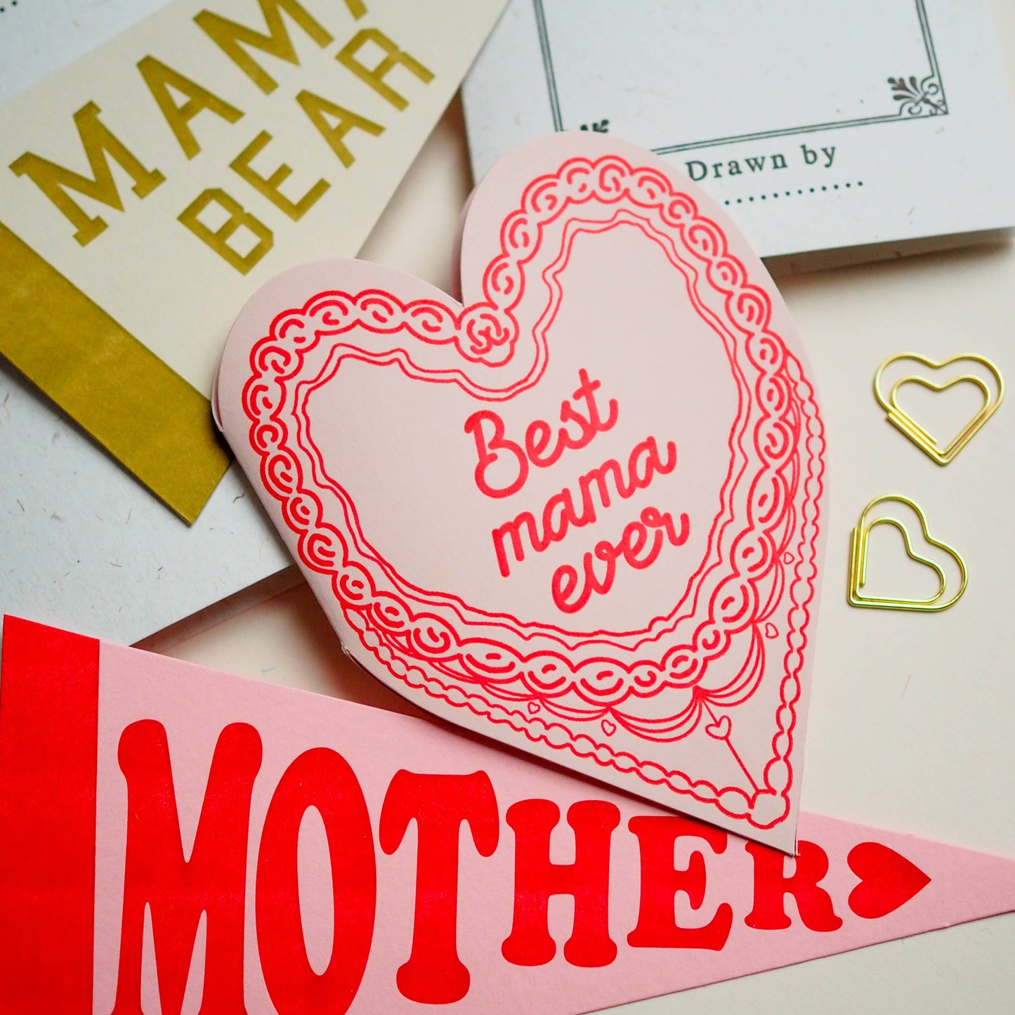 A letter press greeting card featuring a hand drawn retro cake and the words Best Mama ever. Perfect for Mothers Day , new mums & just because. Letter press printed ; die cut on an antique machines.