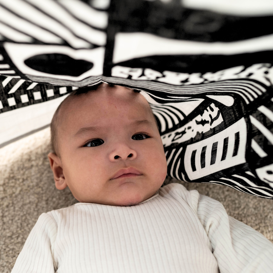 Close-up of Etta Loves x Walala organic cotton muslin, bold geometric design