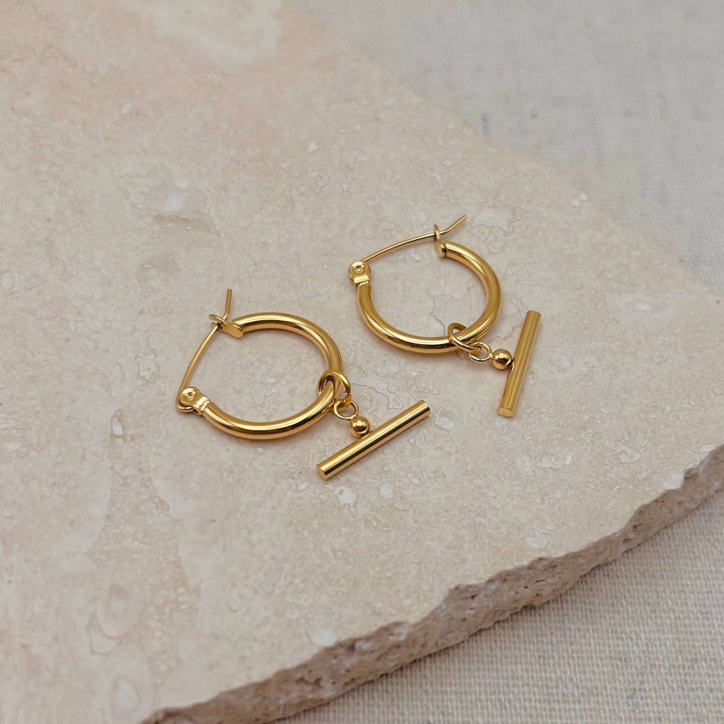 Pair of Little Nell lightweight gold bar hoops with removable charm, waterproof and hypoallergenic