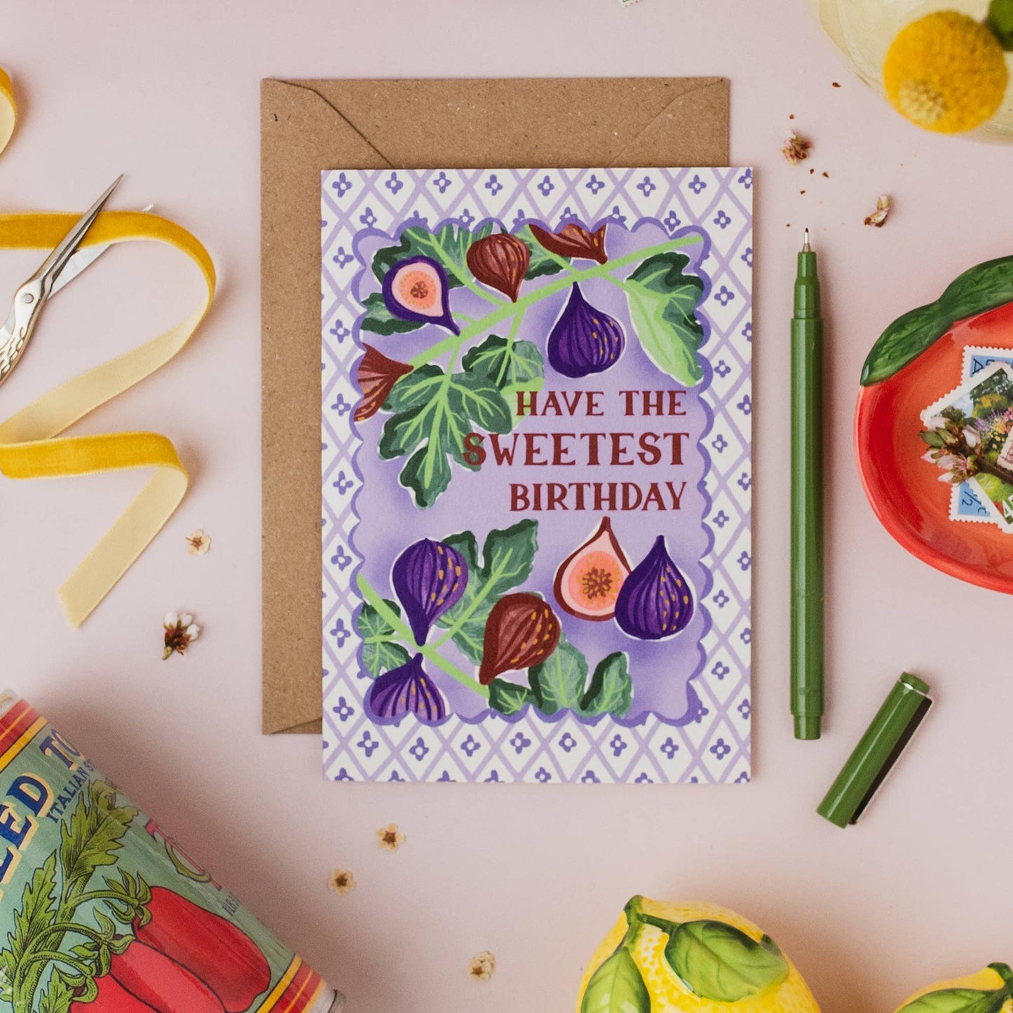 Hand drawn lettering reads 'Have the sweetest birthday'. Part of the on trend Palermo Picnic range, inspired by Italian fruits. Illustrated greeting card with tile pattern and figs illustration, printed onto premium textured card with a kraft envelope.