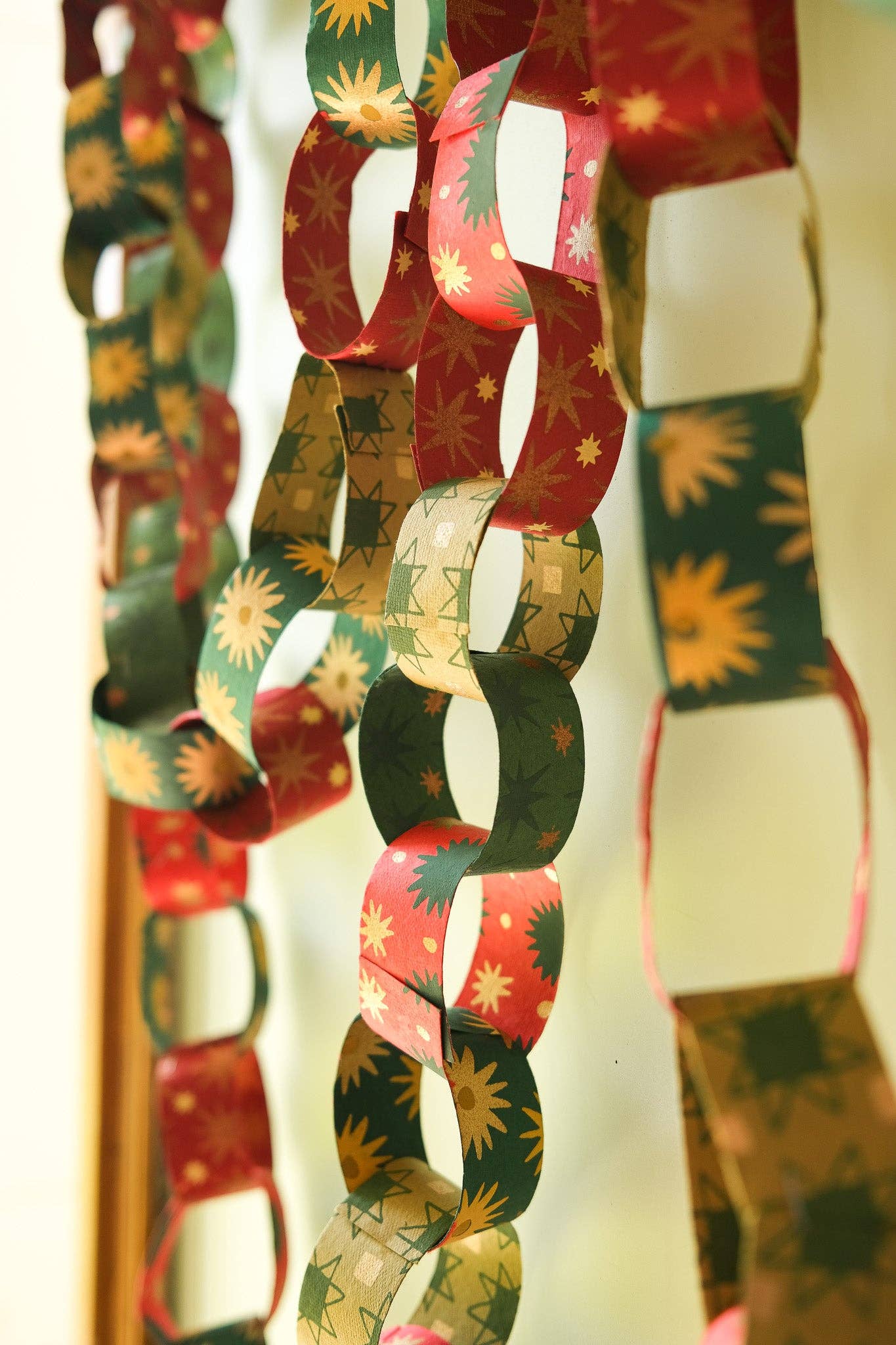 Recycled festive paper chain strips, hand-printed double-sided, eco-friendly decoration kit.