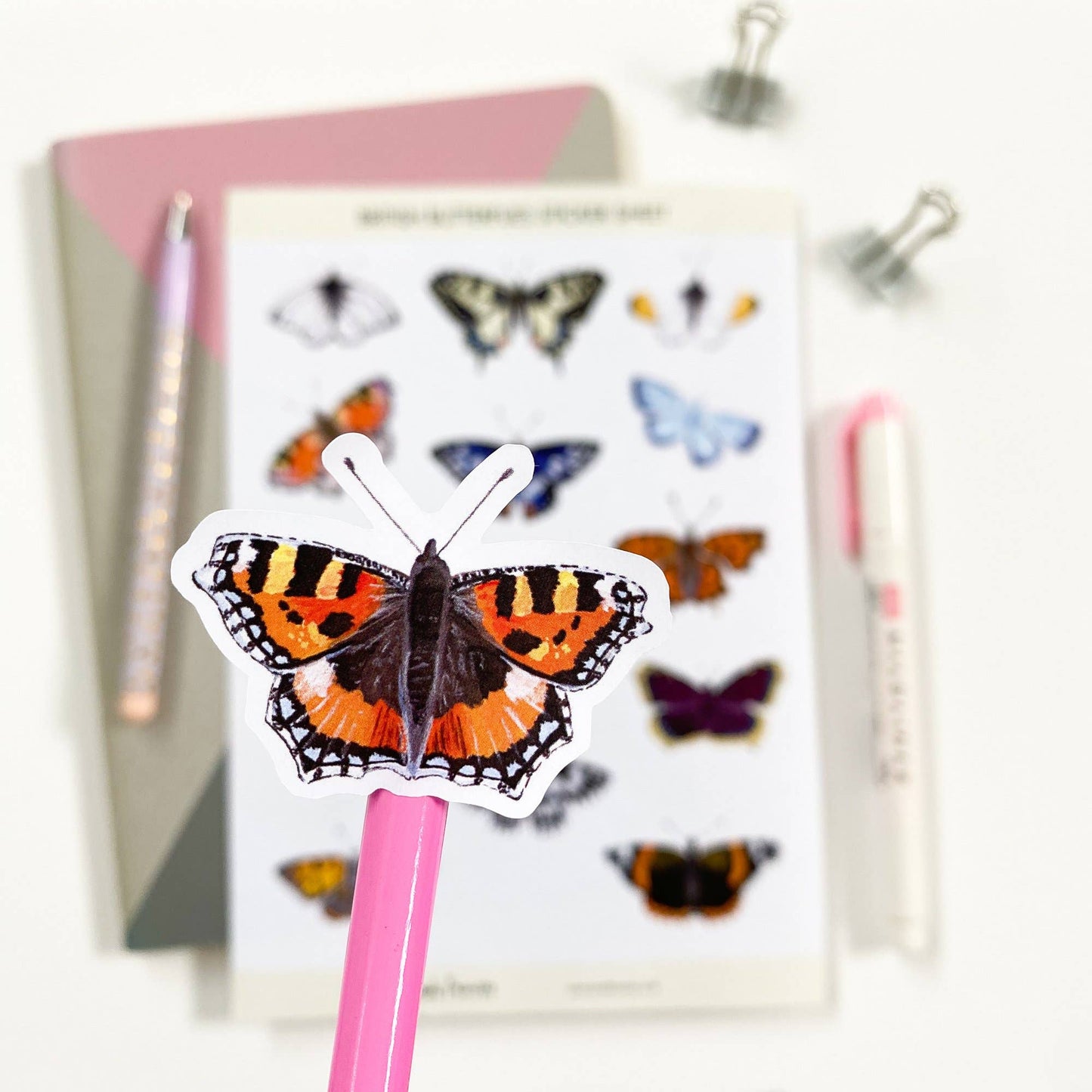 Detailed view of kiss-cut British butterfly stickers ready for peeling