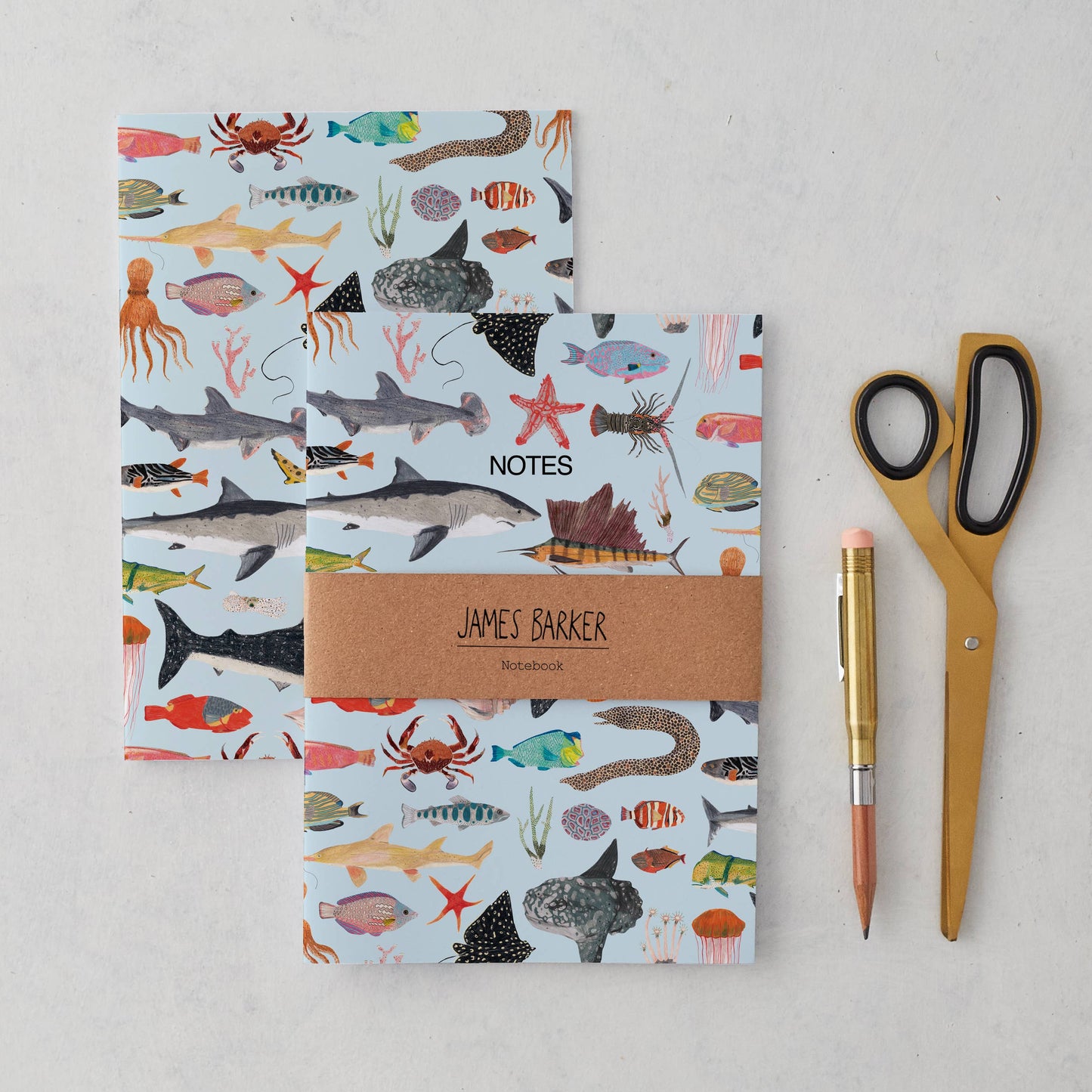 A5 sea life notebook featuring hand-illustrated ocean animals on a blue background, matte finish cover, and kraft belly band. Eco-friendly, UK made.