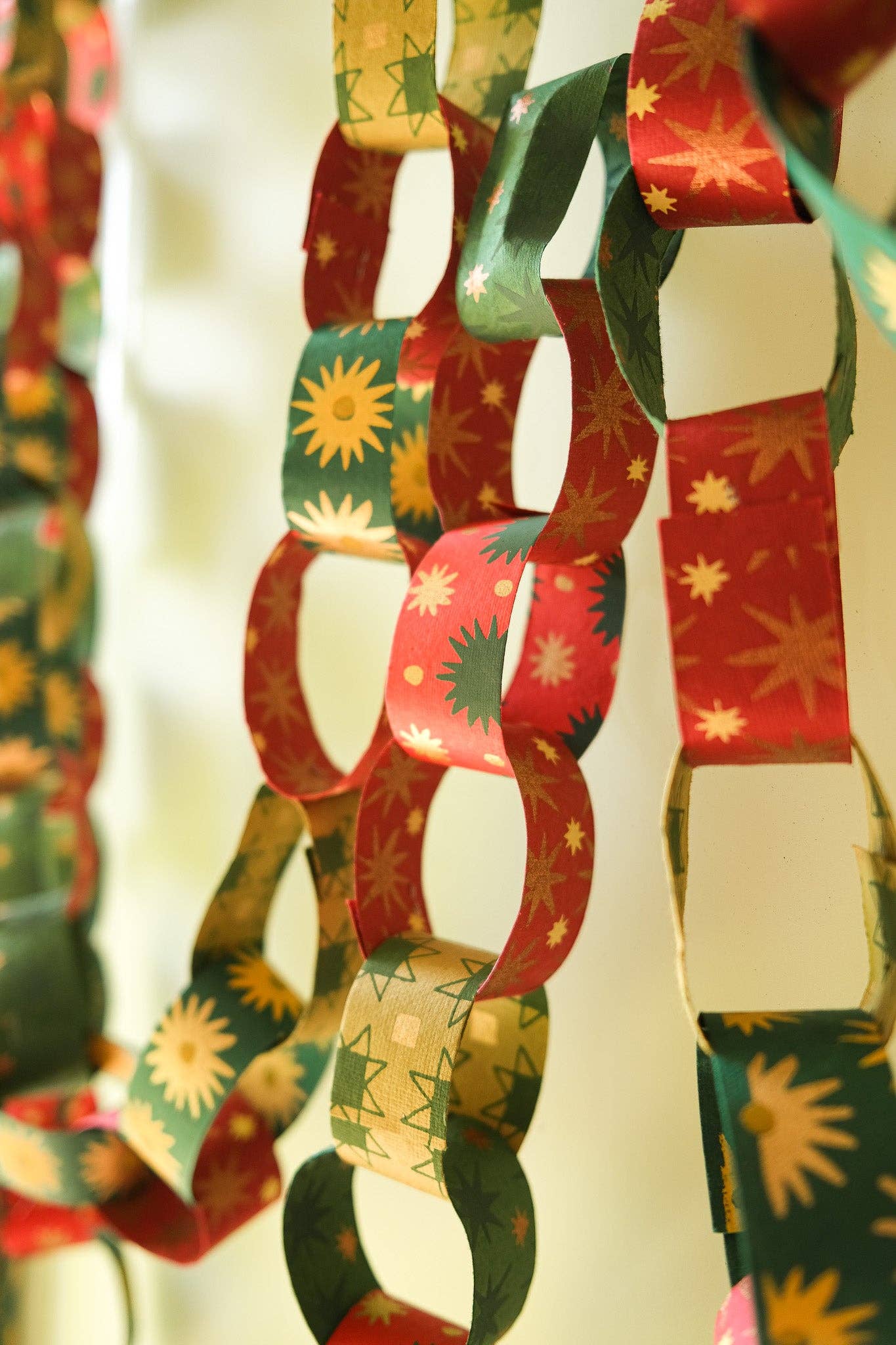 Recycled festive paper chain strips, hand-printed double-sided, eco-friendly decoration kit.