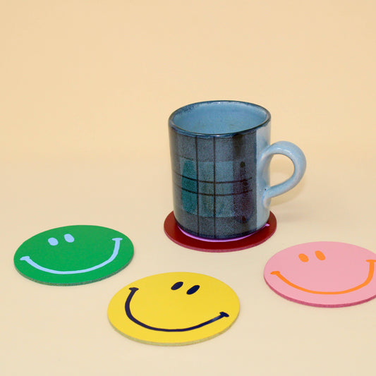 Happy Face Smilie Leather Coasters - Set of 4. Pink, Yellow, Green and Burgundy. Designed and made in the UK.