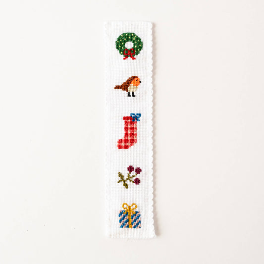 Completed festive cross stitch bookmark featuring stocking and robin