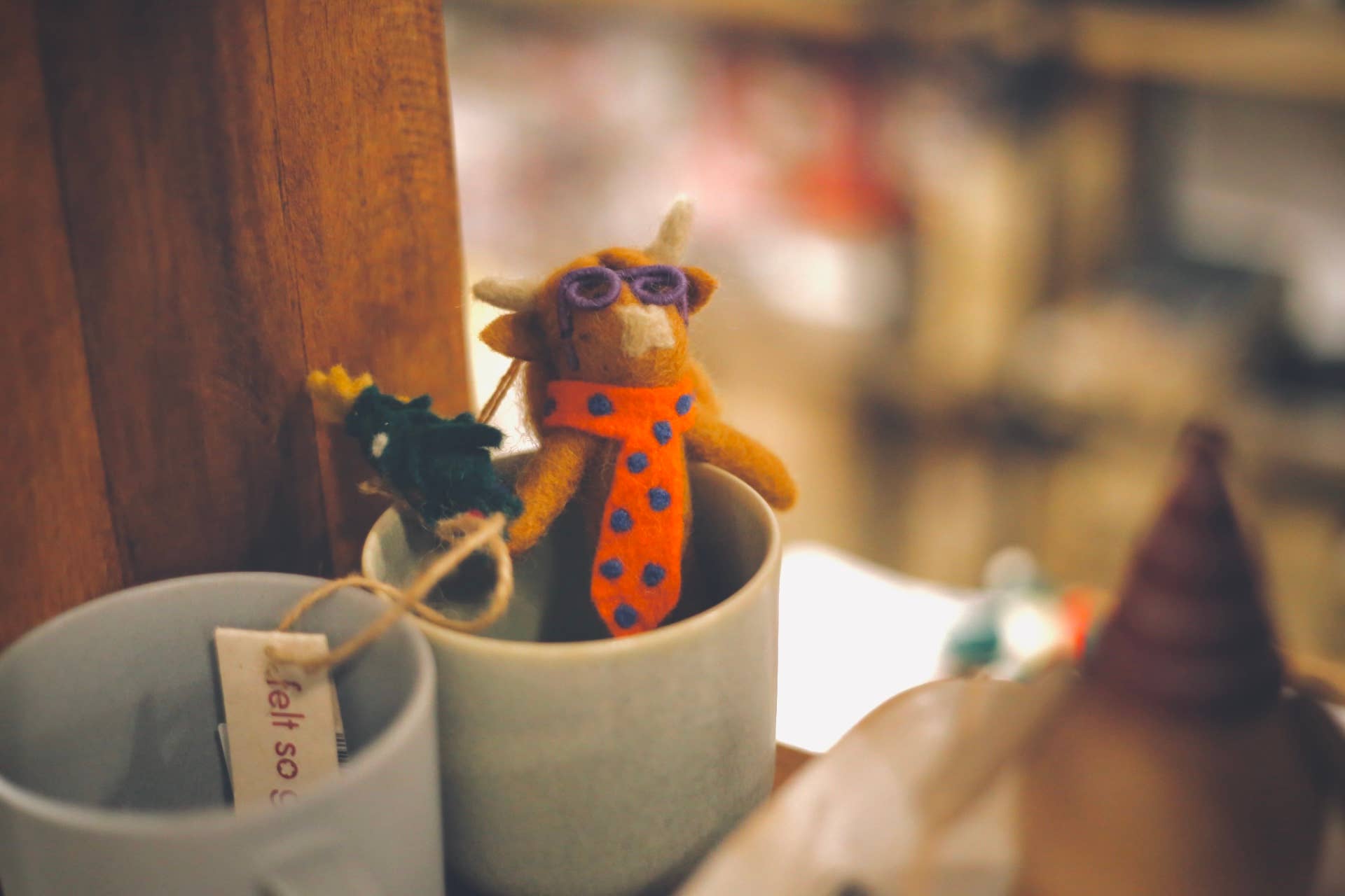 Handmade felt Christmas Cow hanging decoration "Curtis" by Felt So Good, sustainable wool with purple glasses, fair trade and eco-friendly