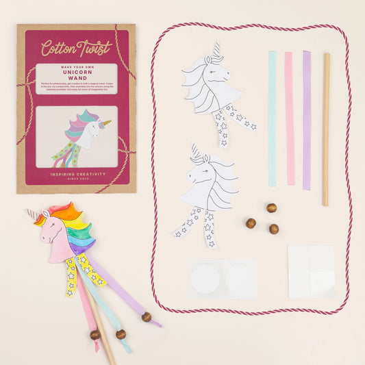 Child making a unicorn wand from the sustainable craft kit, with beads and ribbons