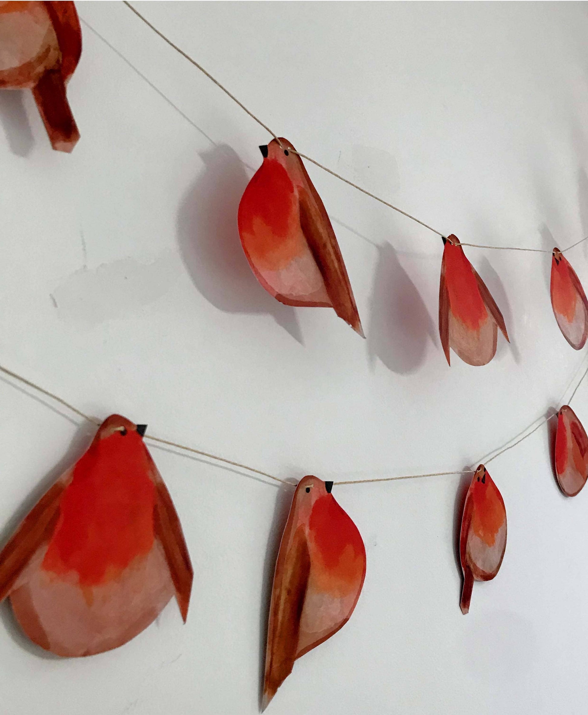 Festive Robin Garland by Wini Tapp featuring 12 double-sided printed robins, 2 metres long, printed on cardstock, strung on hemp string