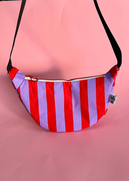 Lilac and red stripe waxed canvas sling bag with adjustable black strap