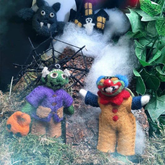 Close-up of handmade felt Frankenstein Halloween decoration, showing stitched smile and gentle expression.