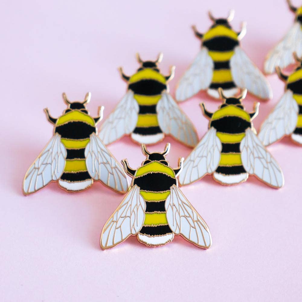 Based on one of Sarah Frances's original watercolour illustrations, this Bee Enamel Pin is perfect for any bee lovers! It will add some serious pin flair to any jacket, bag or cardigan. Made with shiny rose gold metal and hard enamel, the pin measures 1 inch (25mm) at it's widest point. It has a black rubber clutch on the back and will be presented on a small cardboard backer.