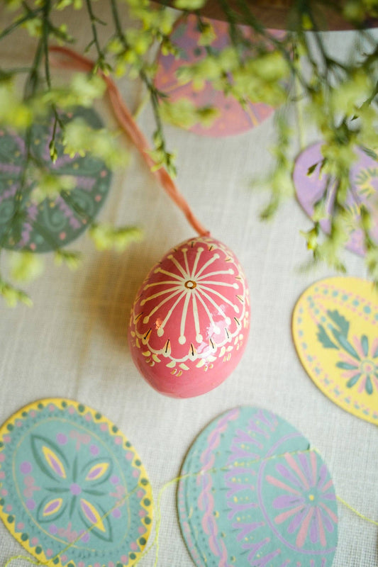 Close up of hand-painted patterns on pink egg