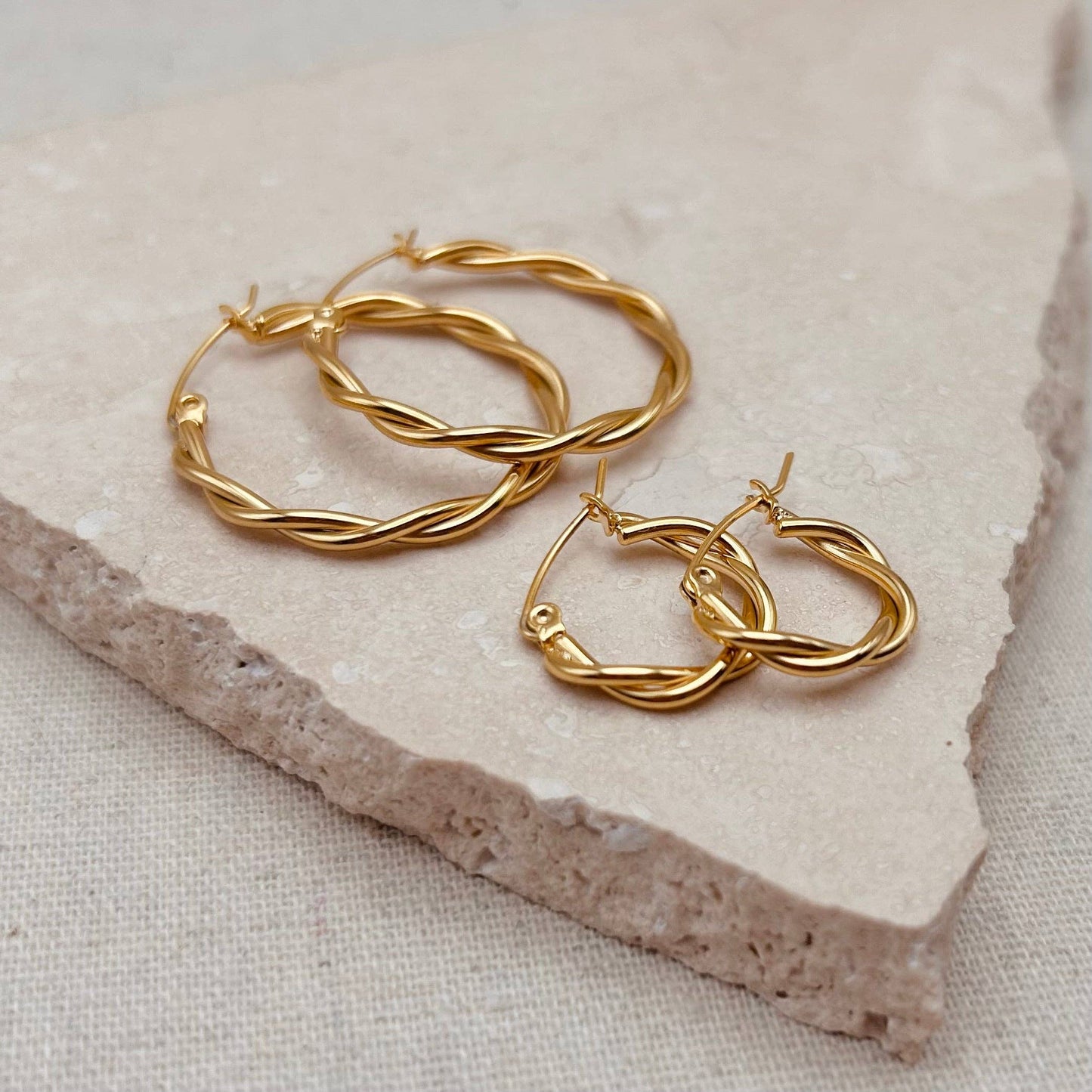 Twisted gold hoop earrings in luxury gift pouch