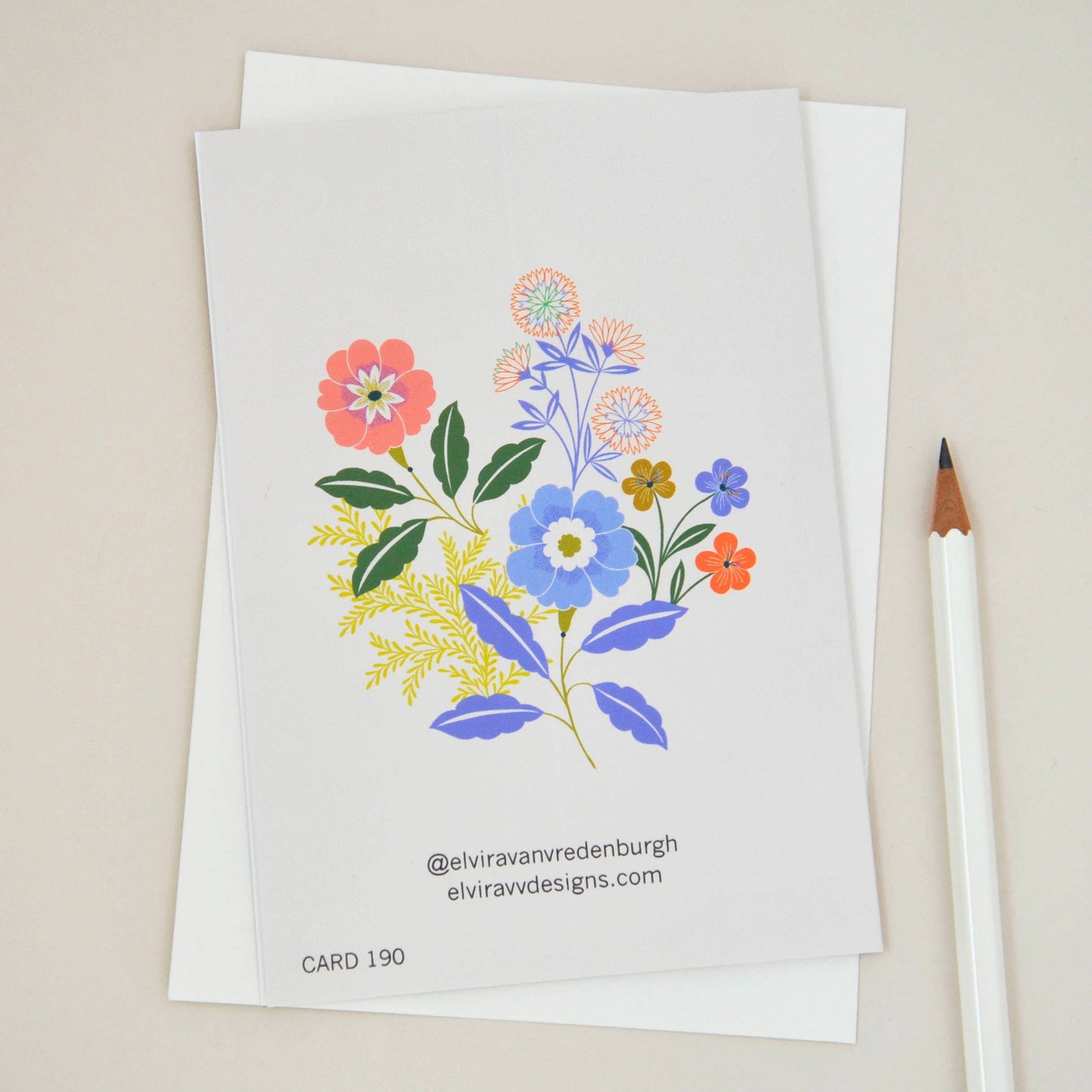 Close-up of 'Sending Love' floral sympathy card, showing detailed colourful flower illustrations.