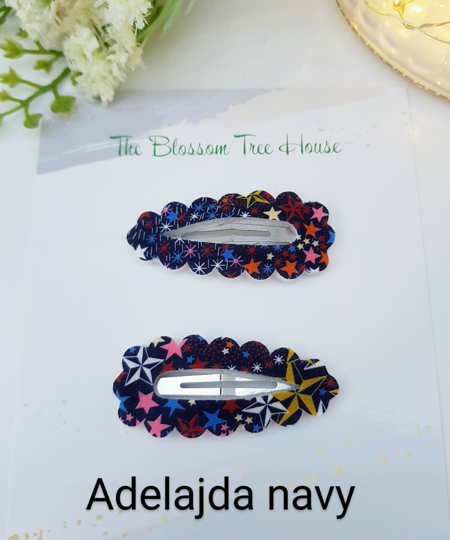 Two colorful hair clips on a white card with 'The Blossom Tree House' branding.