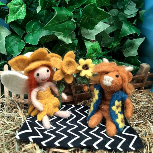 Close-up of Daffodil Fairy with orange hair and white wings, fair trade decor