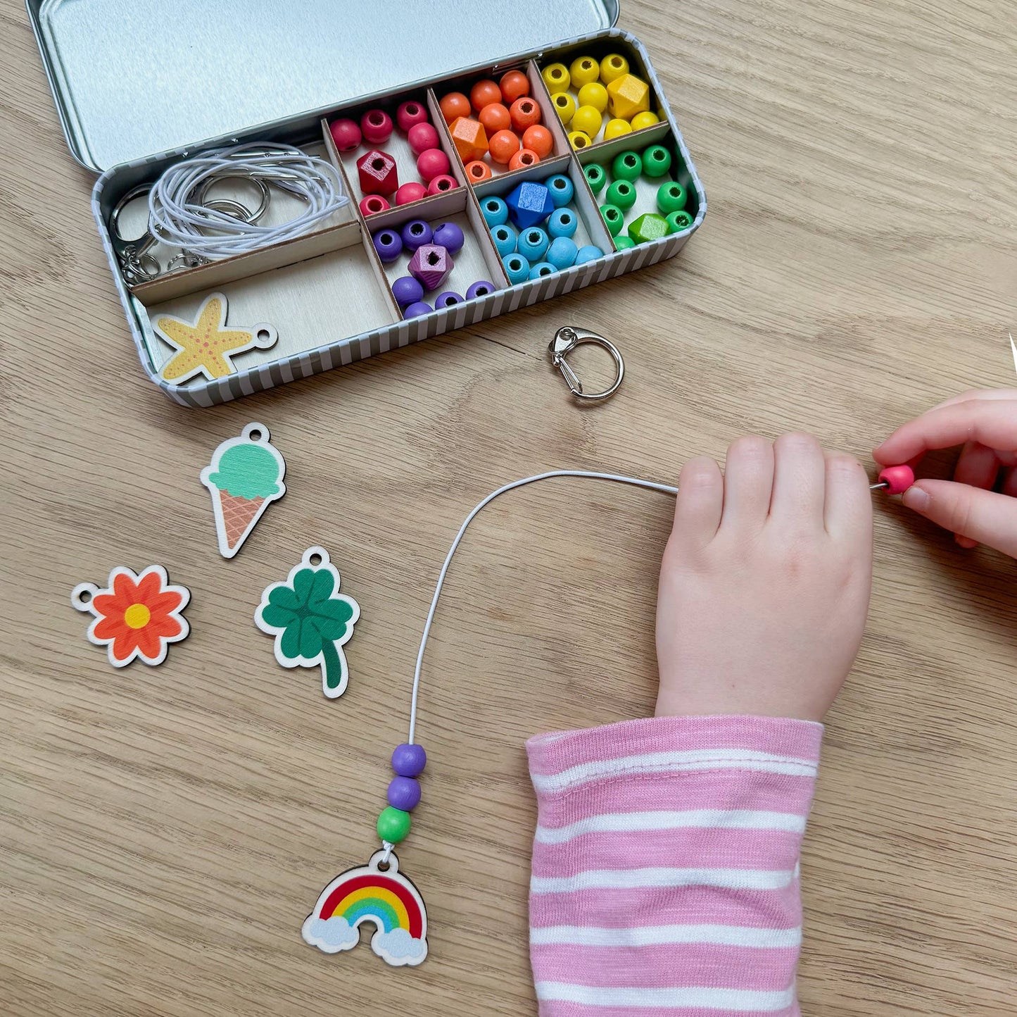 The Lucky Dip Keyring making kit is a wonderful plastic free activity. It offers a selection of wooden fobs to include a clover, flower, starfish, ice cream & a rainbow, allowing children to create 5 keyrings. The kit also comes with rainbow coloured spacer geometric beads to complement the showpiece beads for vibrant accessories!